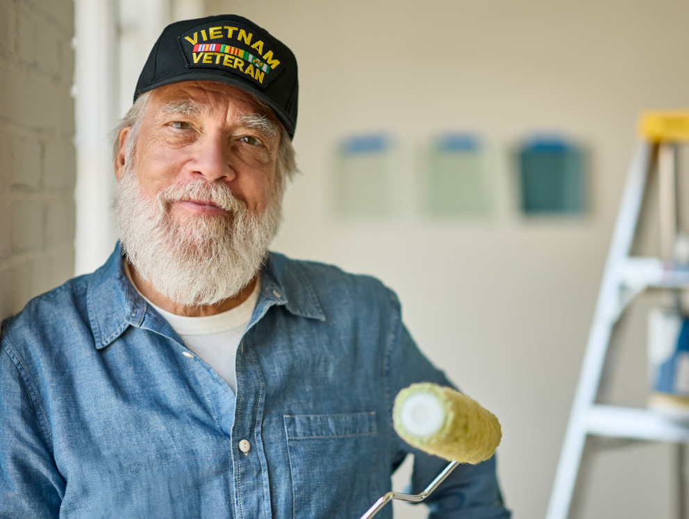 Married couple and husband having a cup of coffee smiling with friend at a street side table